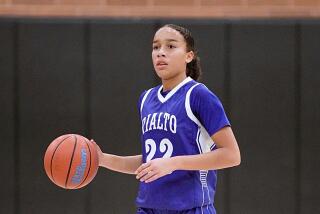 Rialto High junior guard Carrington Davis brings the ball up court during a recent game.