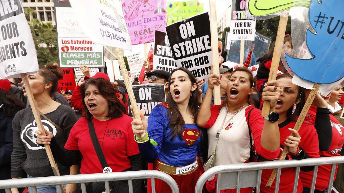 Teachers, from left, Lisa Ynfante, Iris Marin, Janis Nuno and Mireya Gutierrez join thousands of other Los Angeles Unified schoolteachers as they attend a UTLA rally in Grand Park.