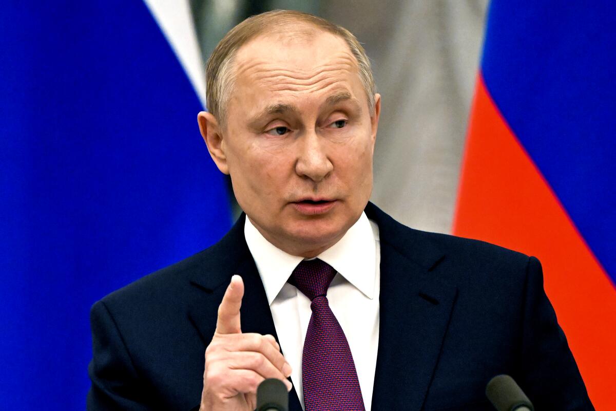 Russian President Vladimir Putin speaks while holding up a finger