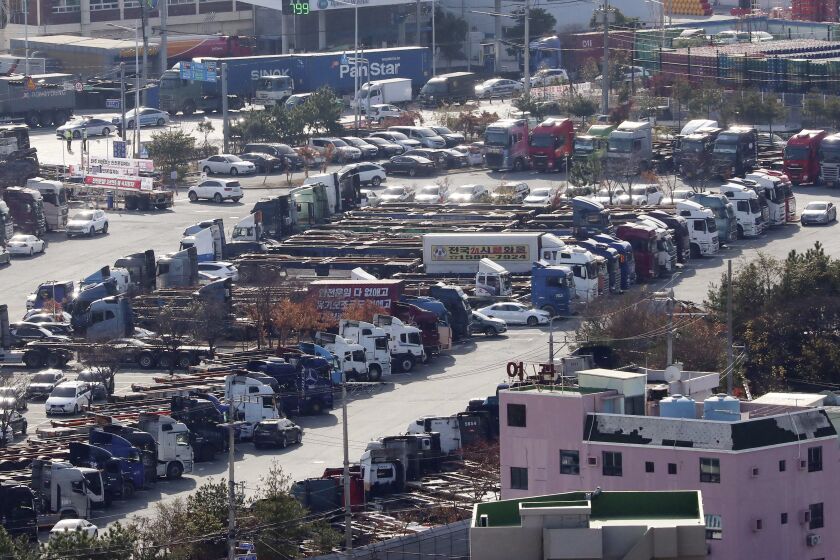 Trucks are parked after drivers went on strike at a port in Busan, South Korea, Thursday, Dec. 8, 2022. South Korea's government expanded its back-to-work orders Thursday against thousands of cargo truck drivers who are staging a nationwide walkout over freight fare issues, saying a prolonged strike could inflict "deep scars" on the country's economy. (Ha Kyung-min/Newsis via AP)