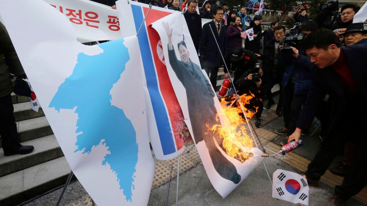 South Koreans burn a portrait of North Korean leader Kim Jong Un in front of the Seoul railway station on Jan. 22, 2018. They were protesting a visit by Hyon Song Wol, head of North Korea's art troupe.