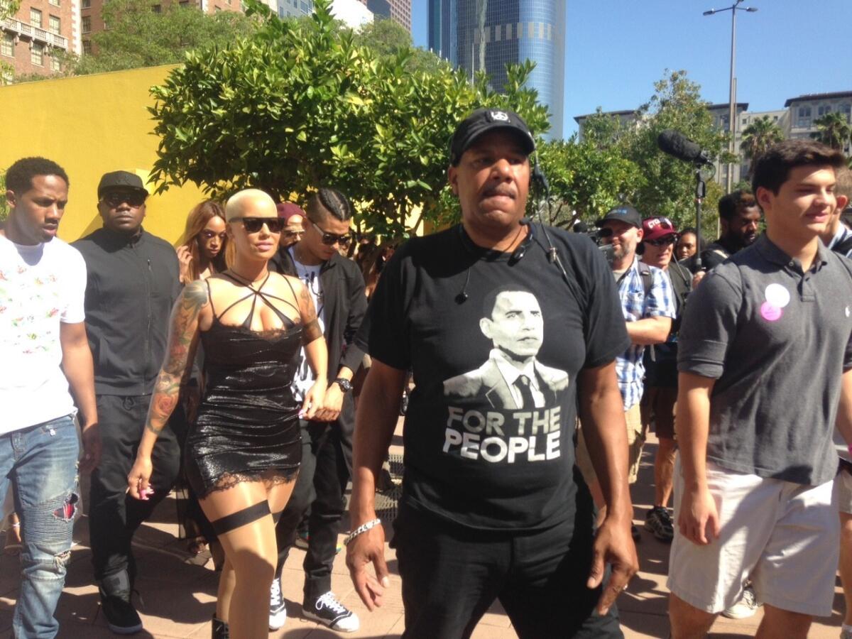 Model Amber Rose, left, leads demonstration at Pershing Square to protest sexism and abuse of women.