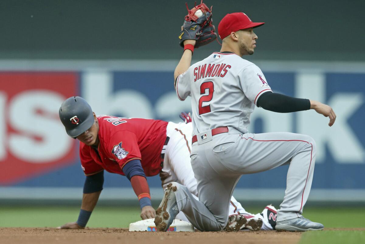 Angels shortstop Andrelton Simmons looks for the call as the Minnesota Twins' Jorge Polanco steals second base in the first inning on May 14 in Minneapolis.