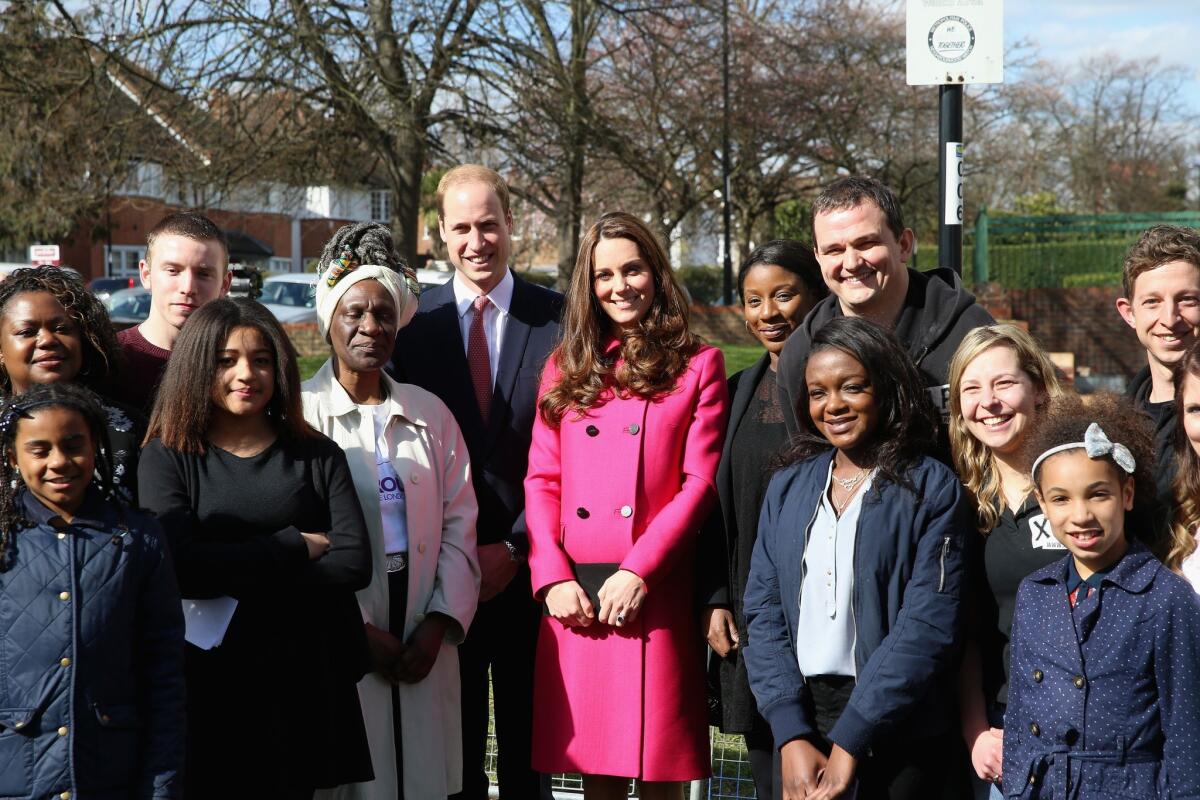 Prince William, Duke of Cambridge, and Catherine, Duchess of Cambridge, pose for a group photograph at the XLP Arts Project and mobile recording studio in London.