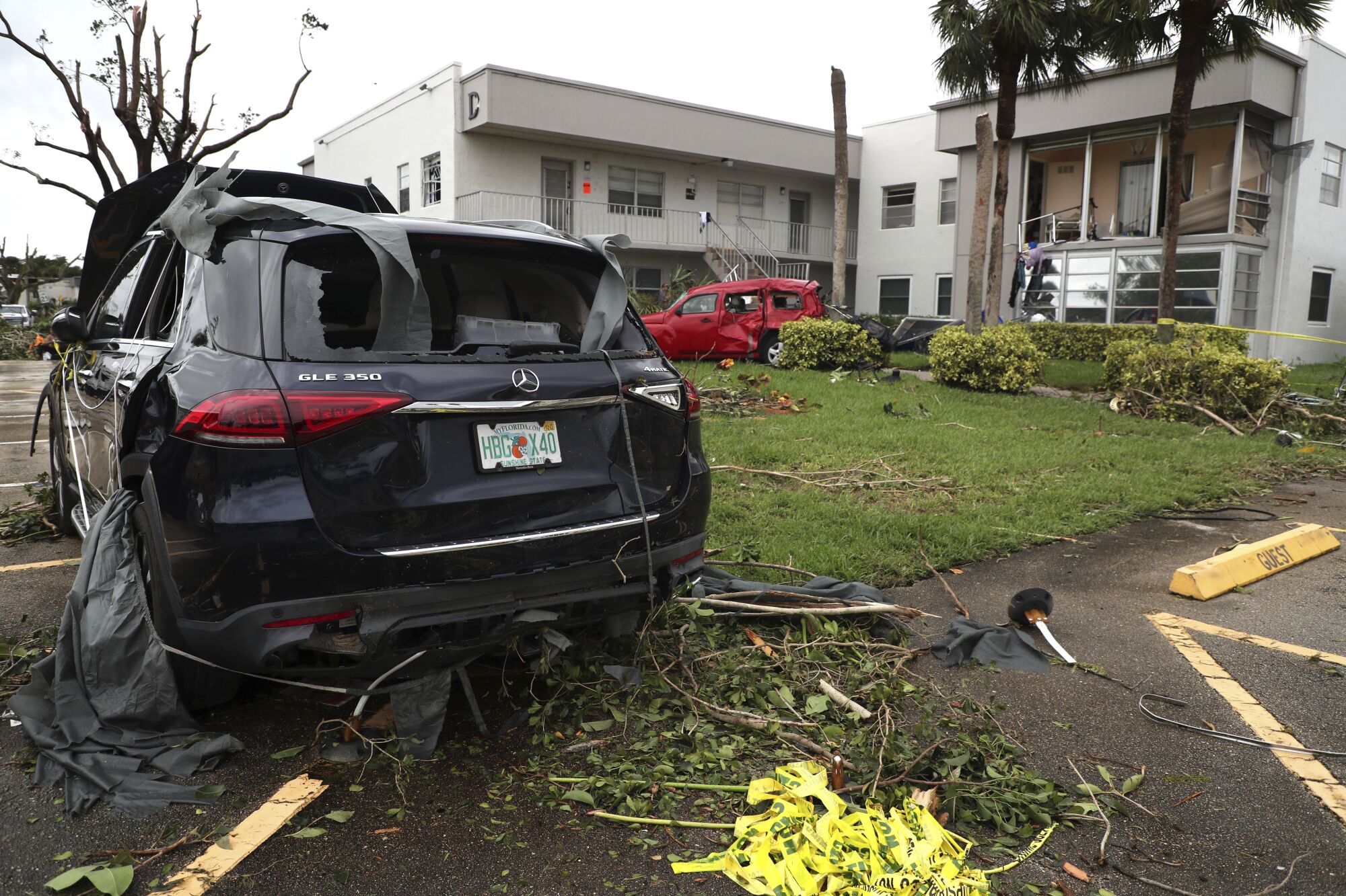 Cars damaged from an apparent overnight tornado spawned from Hurricane Ian at Kings Point 55+ community in Delray Beach, Fla.