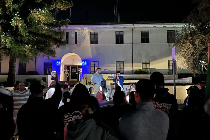 Activist Edin Alex Enamorado and Santa Barbara City Councilmember Oscar Gutierrez speak on the steps of the police station