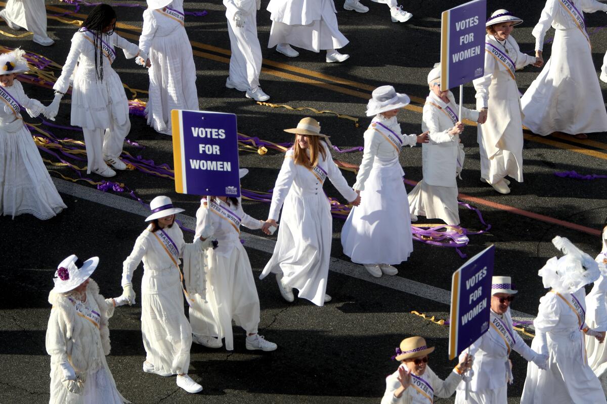 Women dressed as suffragettes march behind the Pasadena Celebrates 2020 during the Jan. 1 Rose Parade. There will be a similar appearance of women so attired during the Fiesta Day Parade May 25 in La Cañada Flintridge.