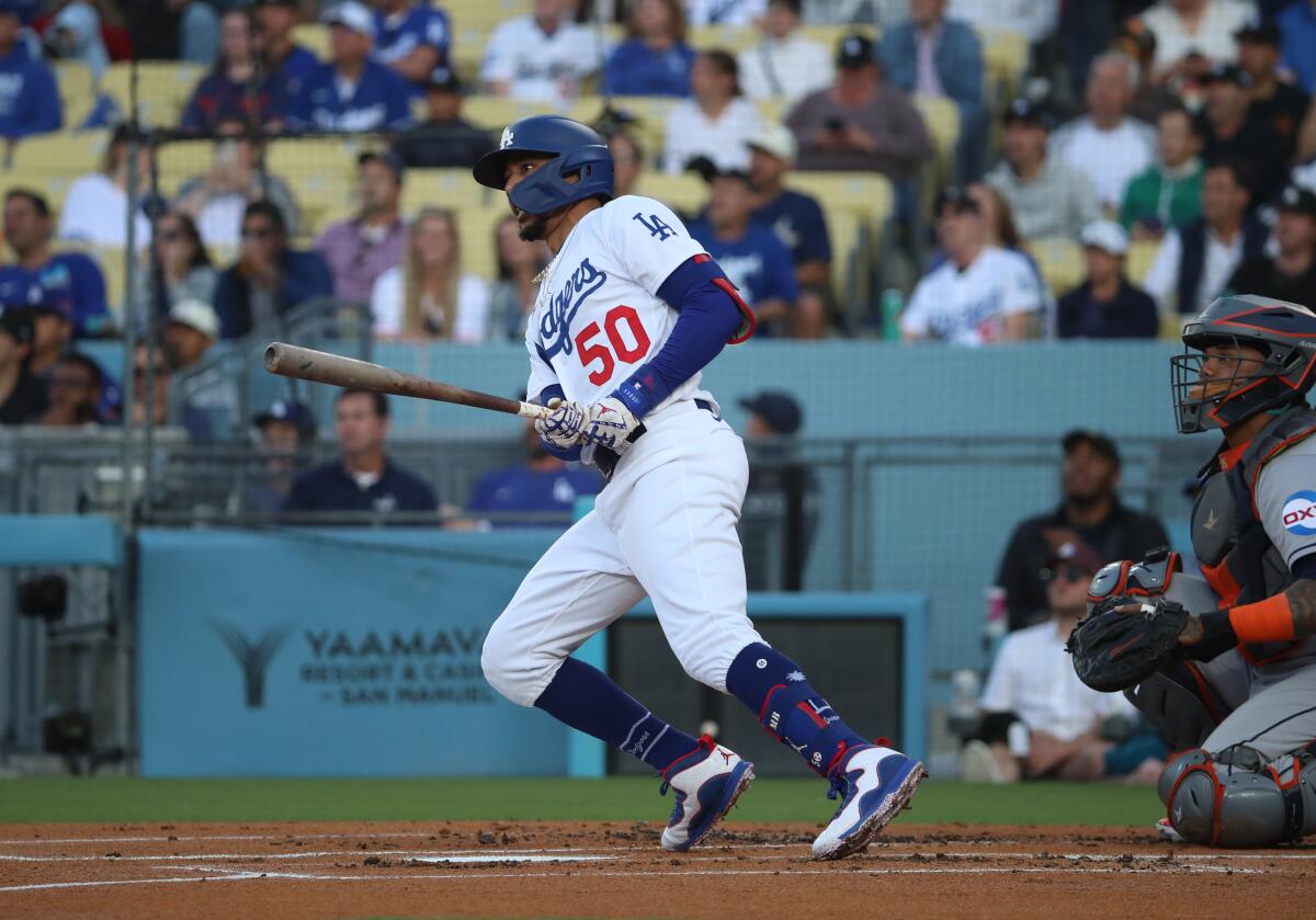 Mookie Betts hits a lead-off home run in the first inning for the Dodgers on Friday night.