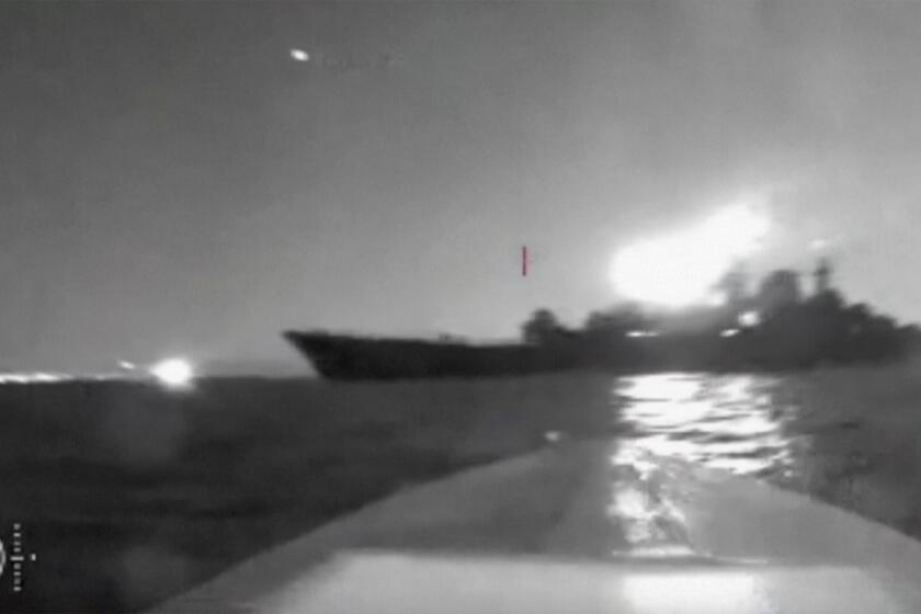 In this grab taken from video released on Friday, Aug. 4, 2023, a drone manoeuvers as it approaches the vessel claimed to be a Russian large landing ship, the Olenegorsky Gonyak, close to the Black Sea port of Novorossiysk. Russia had accused Ukraine of attacking its Black Sea navy base in the port of Novorossiysk with sea drones. (via AP)