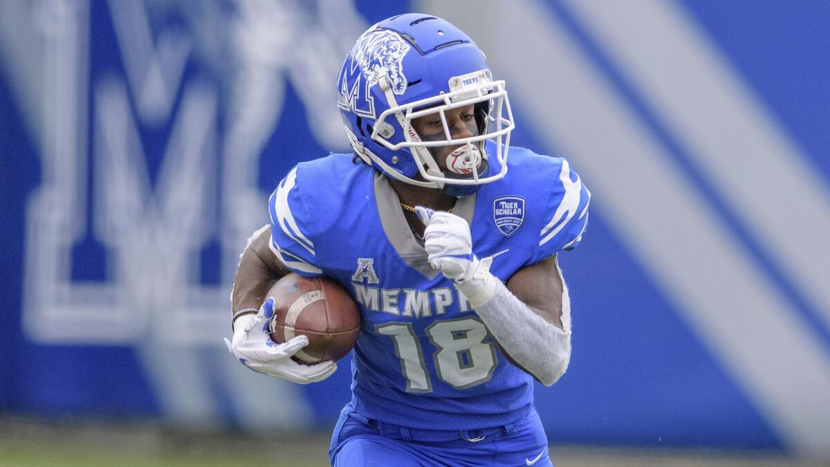 Memphis wide receiver Tahj Washington (18) runs with the ball during a game against Temple