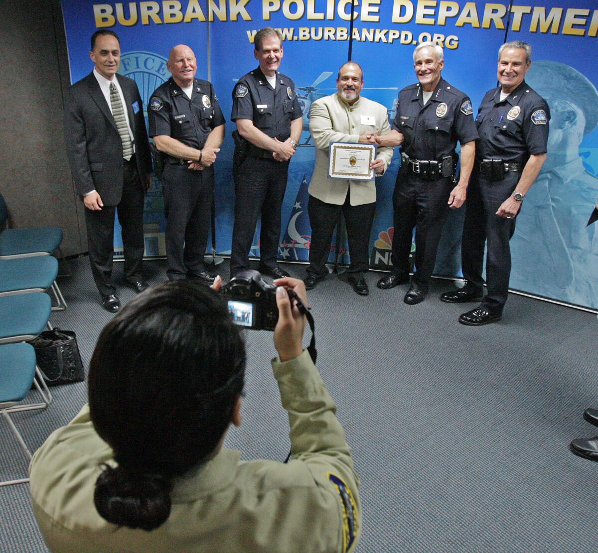 Robert Vincent stands with Police Chief Scott LaChasse and his members of his staff for a photo at the Burbank Police Department for the BPD Community Academy graduation ceremony on Thursday, November 13, 2014. The 28th class is the largest class the BPD has graduated.