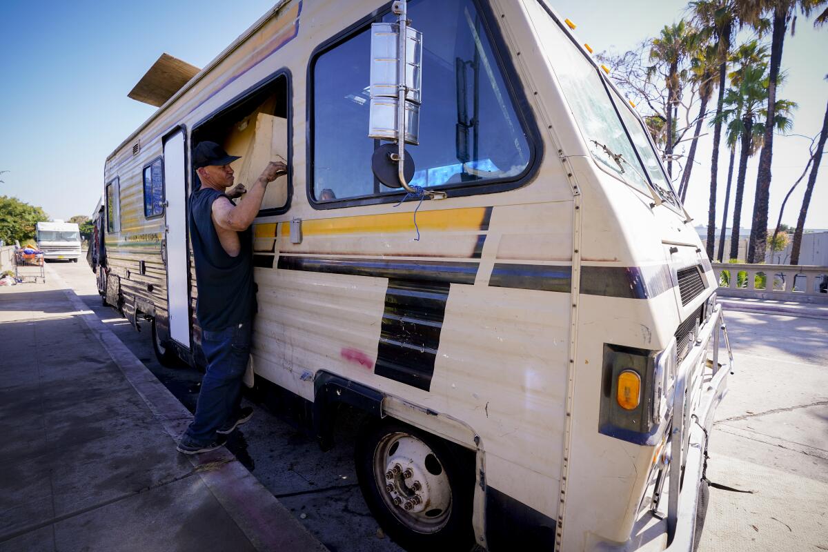 , Jerrod Starbird used a large section of cardboard to replace the glass in his RV’s window frame.