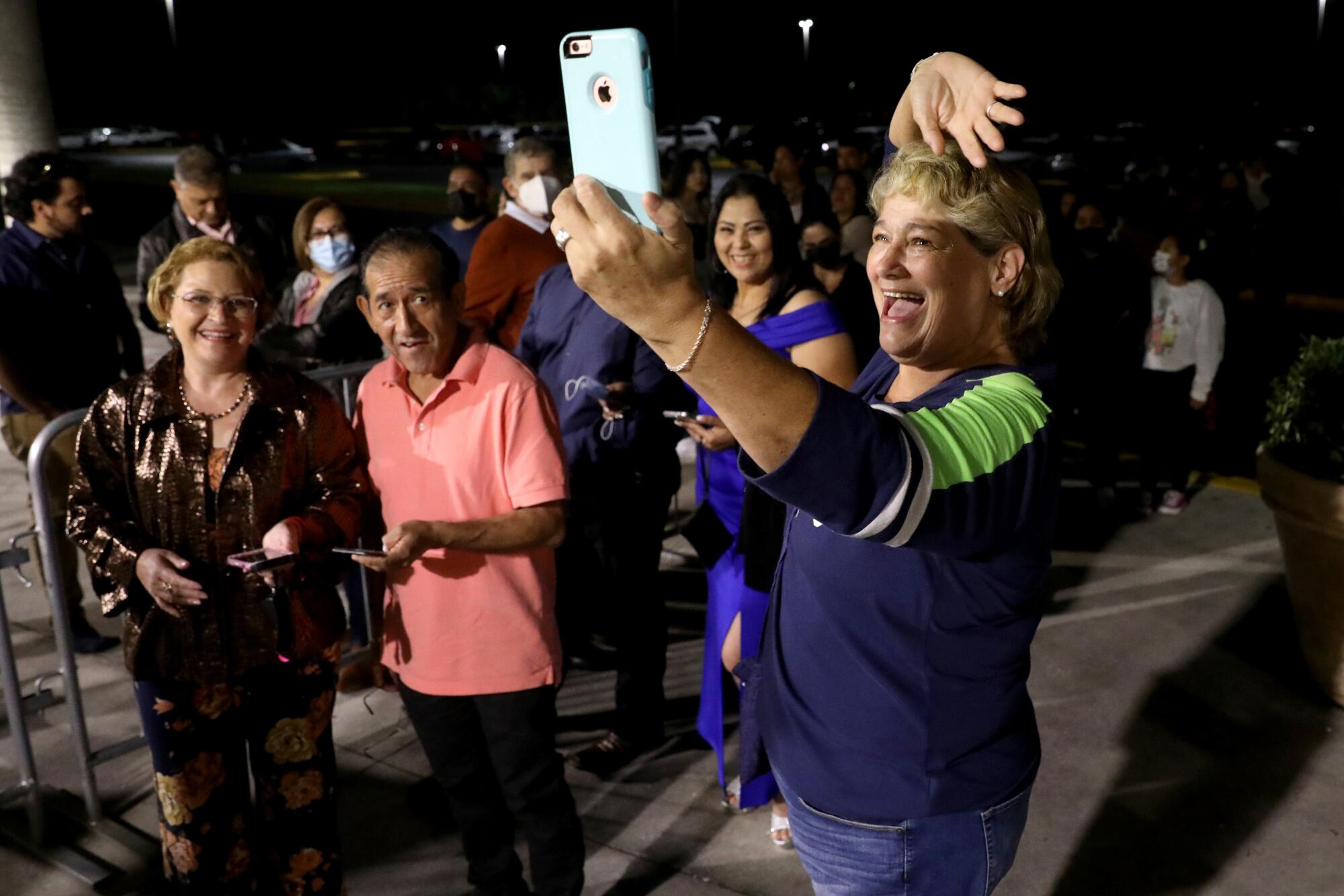 Lucy Garcia, 60, of Cape Coral, Fla., waves on a live video stream.