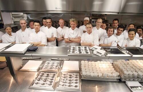 Chef Gordon Ramsay poses with his kitchen staff at the opening part for the London West Hollywood on June 4.