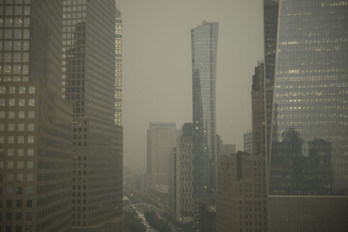 Buildings in lower Manhattan in New York are partially obscured by smoke from Canadian wildfires on Tuesday, June 6, 2023. (AP Photo/Patrick Sison)