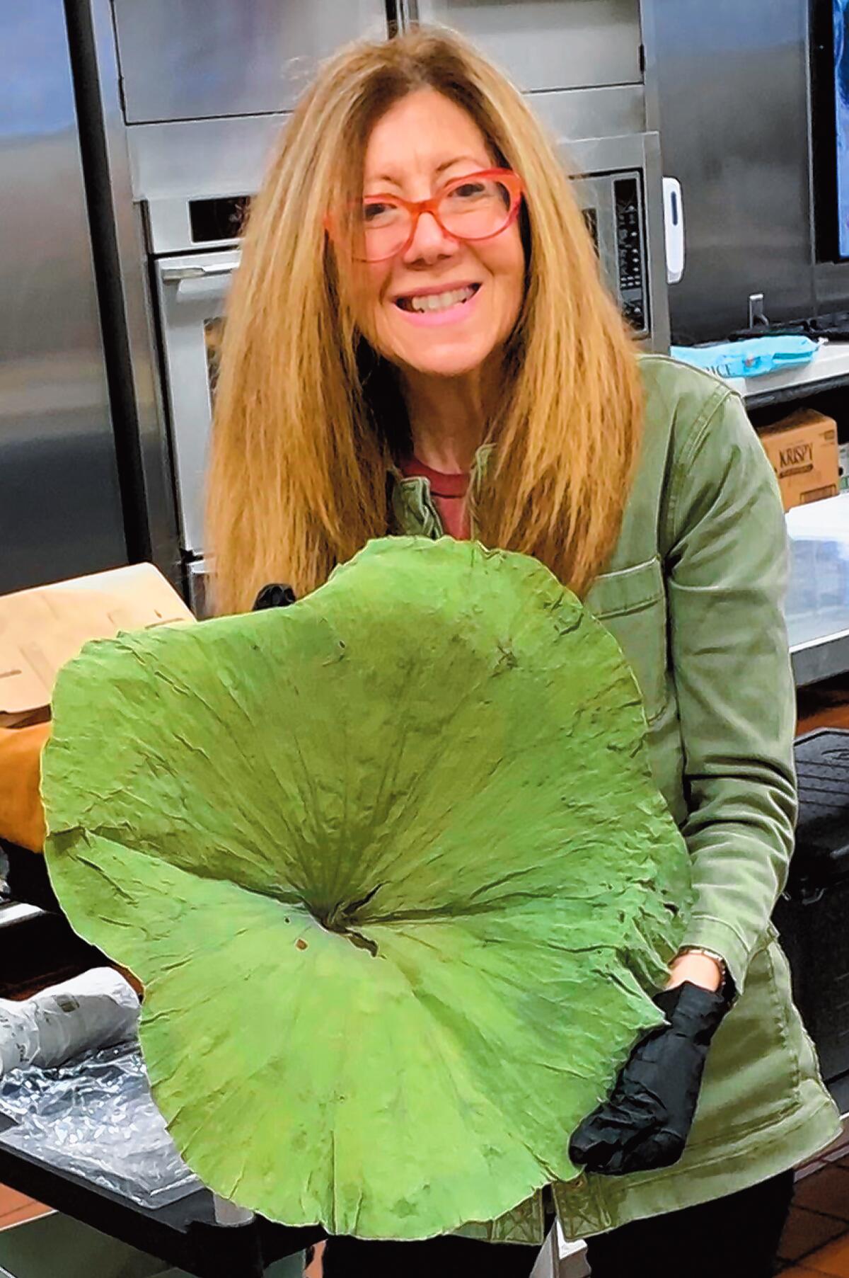 "Kitchen Shrink" Catharine Kaufman with a lotus leaf