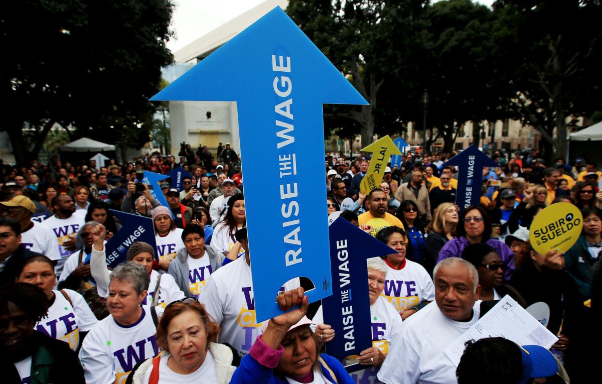 A coalition of workers, businesspeople and civic leaders rally outside Los Angeles City Hall to raise the minimum wage on Friday, Jan. 30, 2015.
