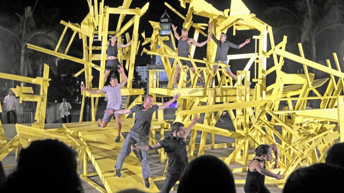 Bodytraffic dancers snake through artist Gustavo Godoy’s sculpture in the Music Center plaza.