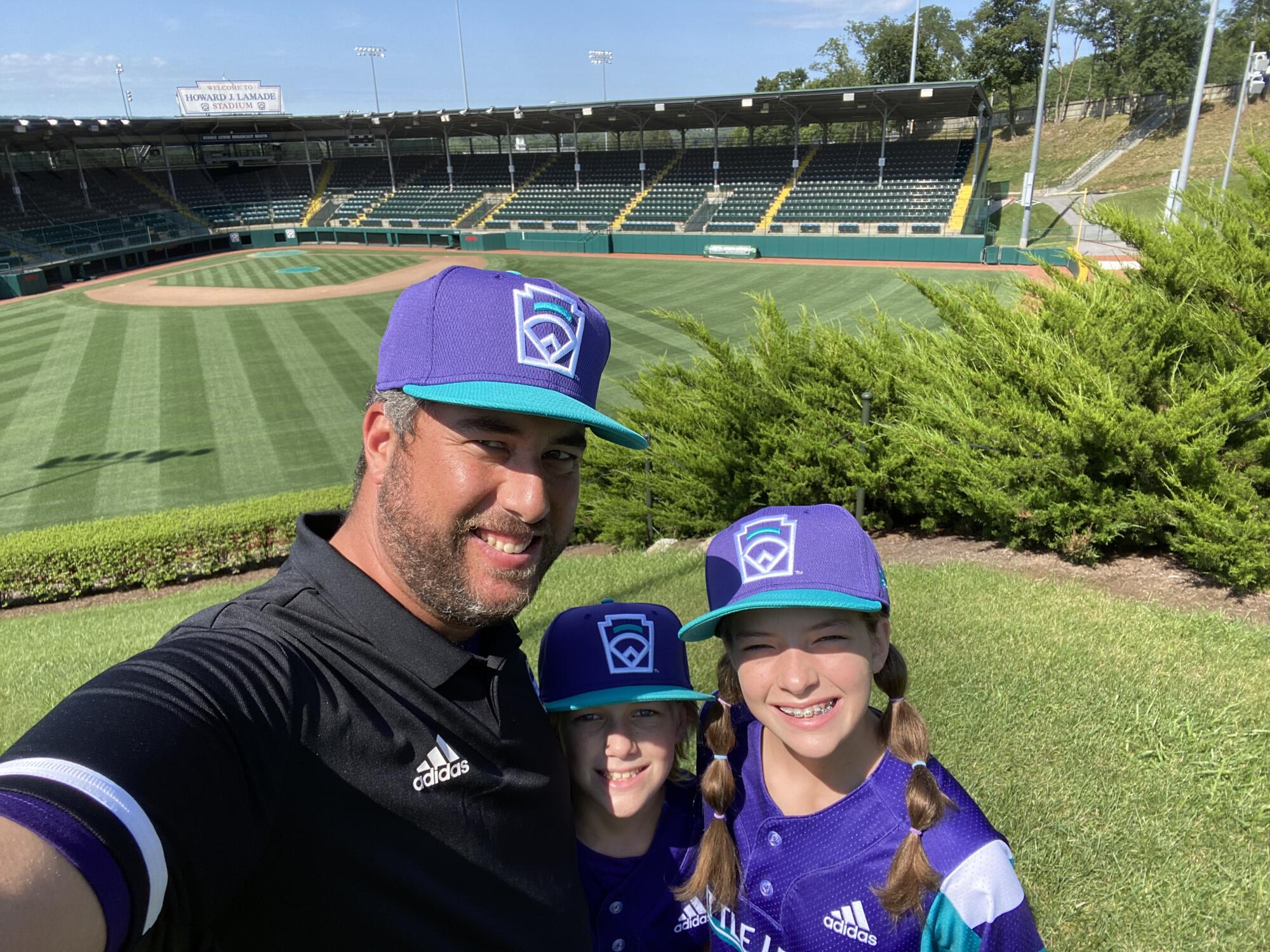 Photo of Bryan Bruning, left to right, Dillon Bruning and Ella Bruning in Little League headquarters complex