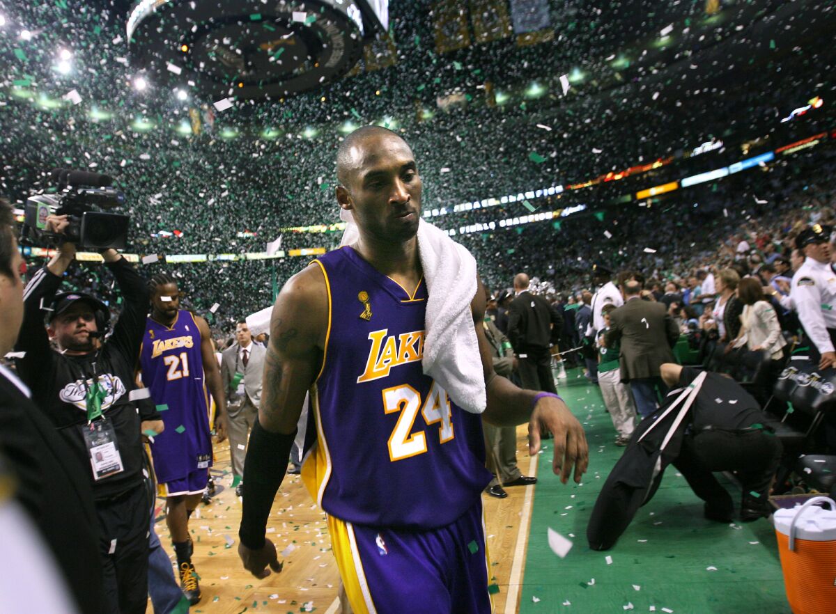 Kobe walks off the court as the Celtics celebrate the Championship. (Wally Skalij / Los Angeles Times)