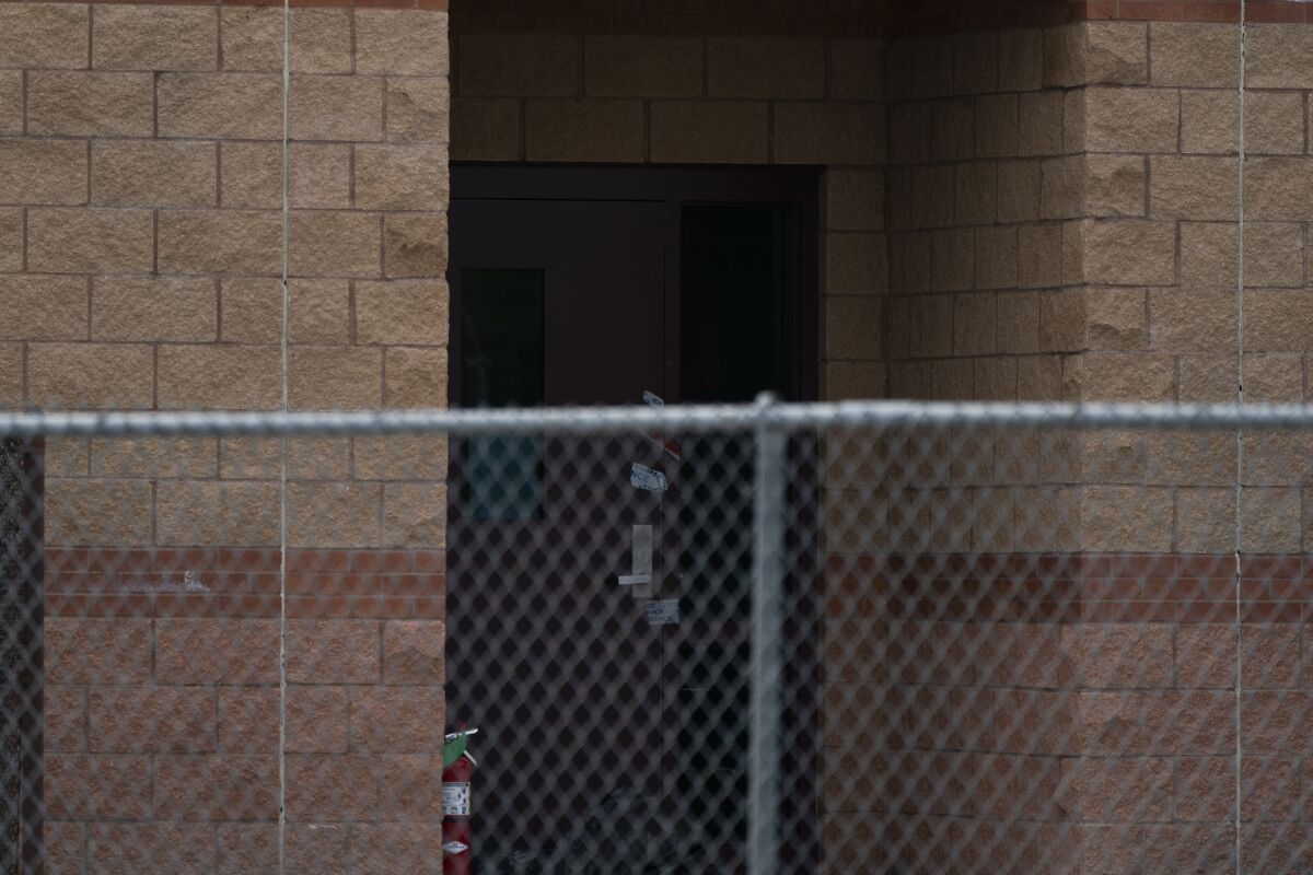 A back door at Robb Elementary School, where a gunman entered through to get into a classroom in last week's shooting, is photographed, Wednesday, June 1, 2022, in Uvalde, Texas. (AP Photo/Jae C. Hong)