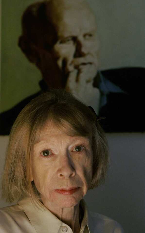 Didion poses in front of a portrait of her husband, screenwriter and novelist John Gregory Dunne, in her New York apartment. Didion's memoir, "The Year of Magical Thinking," deals with her grief after Dunne's sudden death from a heart attack in December 2003.