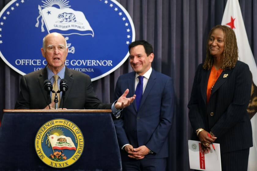 LOS ANGELES, CALIF. -- WEDNESDAY, JUNE 27, 2018: Gov. Jerry Brown, shown with from left, Senate President Pro Tem Toni Atkins, Assembly Speaker Anthony Rendon (D-Paramount) and Sen. Holly Mitchell (D-Los Angeles) before signing the 2018-19 California budget at the Ronald Reagan State Building in Los Angeles, Calif., on June 27, 2018. (Gary Coronado / Los Angeles Times)