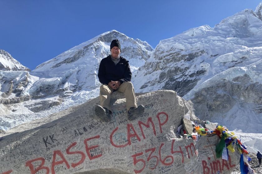 John Montague atop Mt. Everest base camp marker on Khumbu glacier.