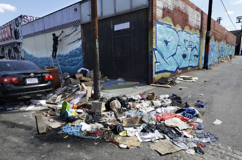 A pile of trash sits uncollected on Santee St. in between 18th St