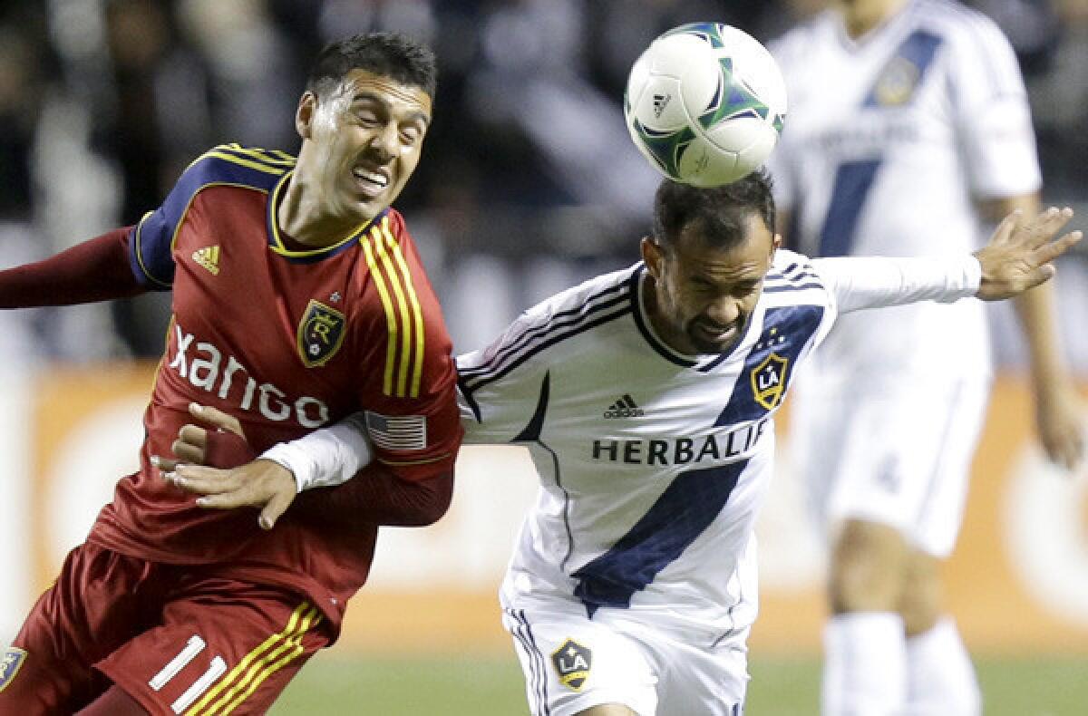 Galaxy midfielder Juninho heads the ball away from Real Salt Lake's Javier Morales during an MLS playoff game last season.