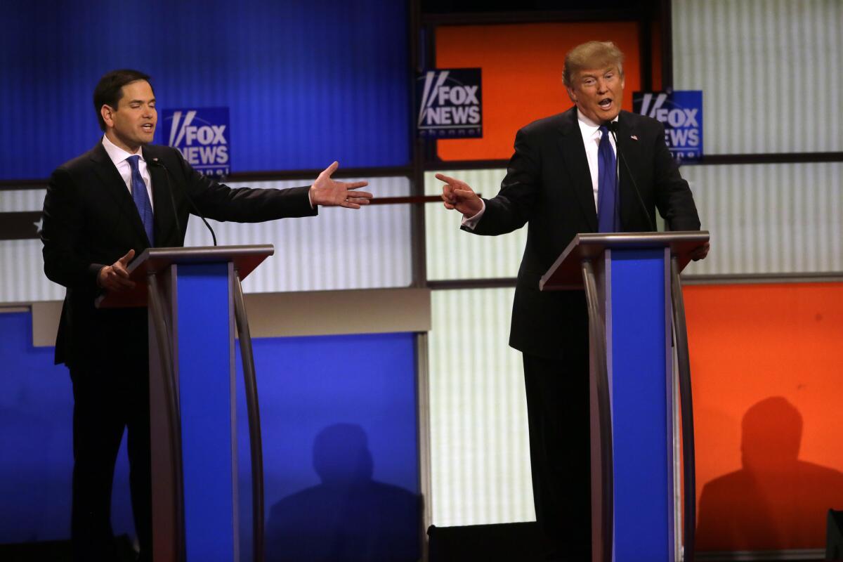 Republican presidential candidates Sen. Marco Rubio, left, and businessman Donald Trump argue during a Republican primary debate on Thursday at Fox Theatre in Detroit.