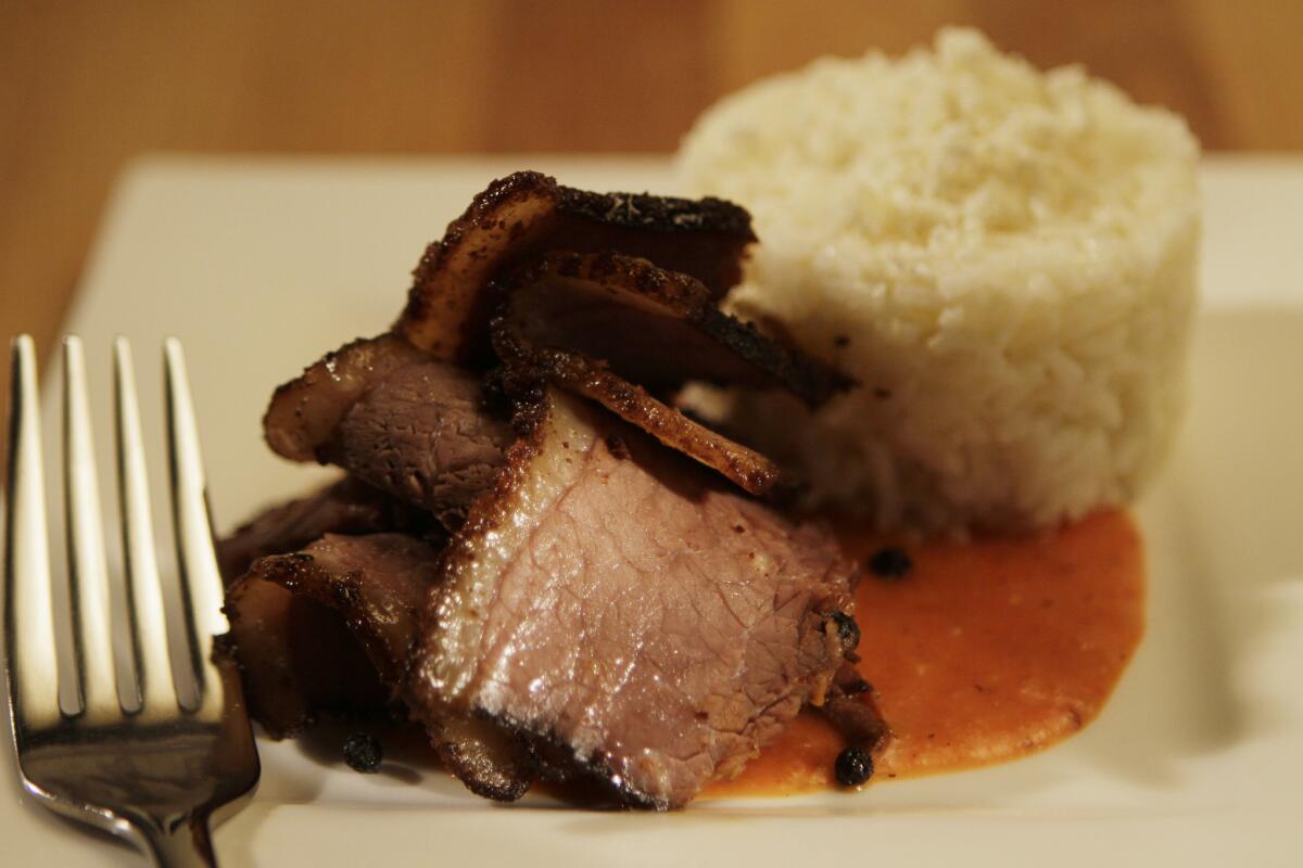 La Sandia's smoked brisket is served with cotija white rice and salsa pibil. Recipe