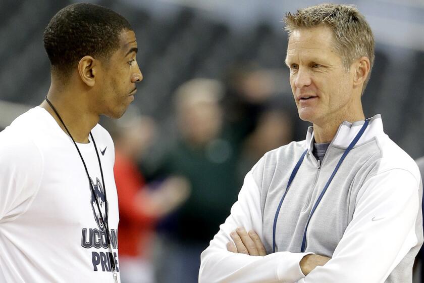 Then television analysts Steve Kerr, right, chats with Connecticut Coach Kevin Ollie before a Final Four game.