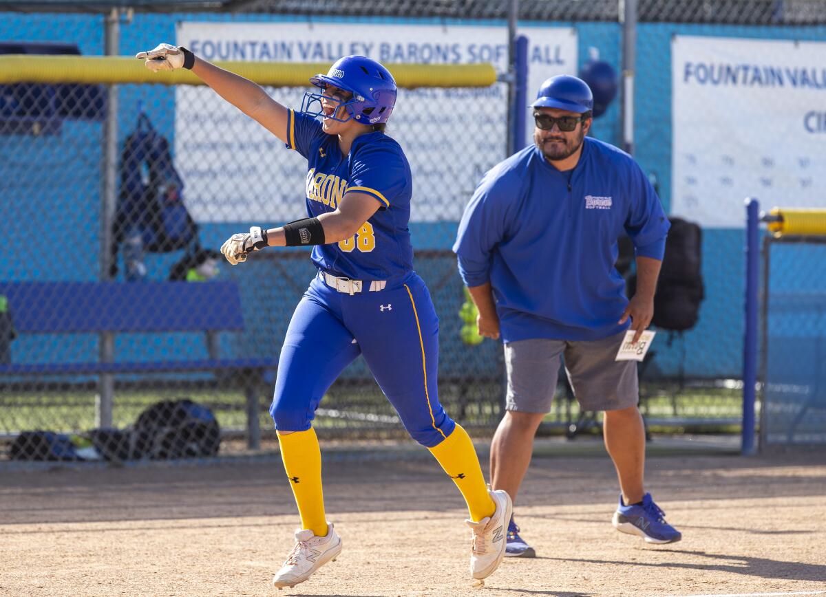 Fountain Valley's Makenzie Butt gestures to her teammates after hitting a two-run home run against Barstow on May 5.