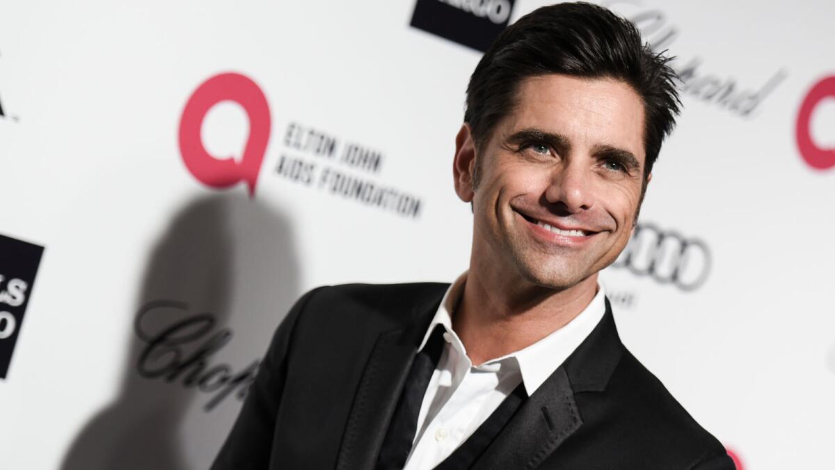 John Stamos, shown Feb. 22 at the AIDS Foundation Oscar party, had a little fun recently outside the "Full House" abode in San Francisco.