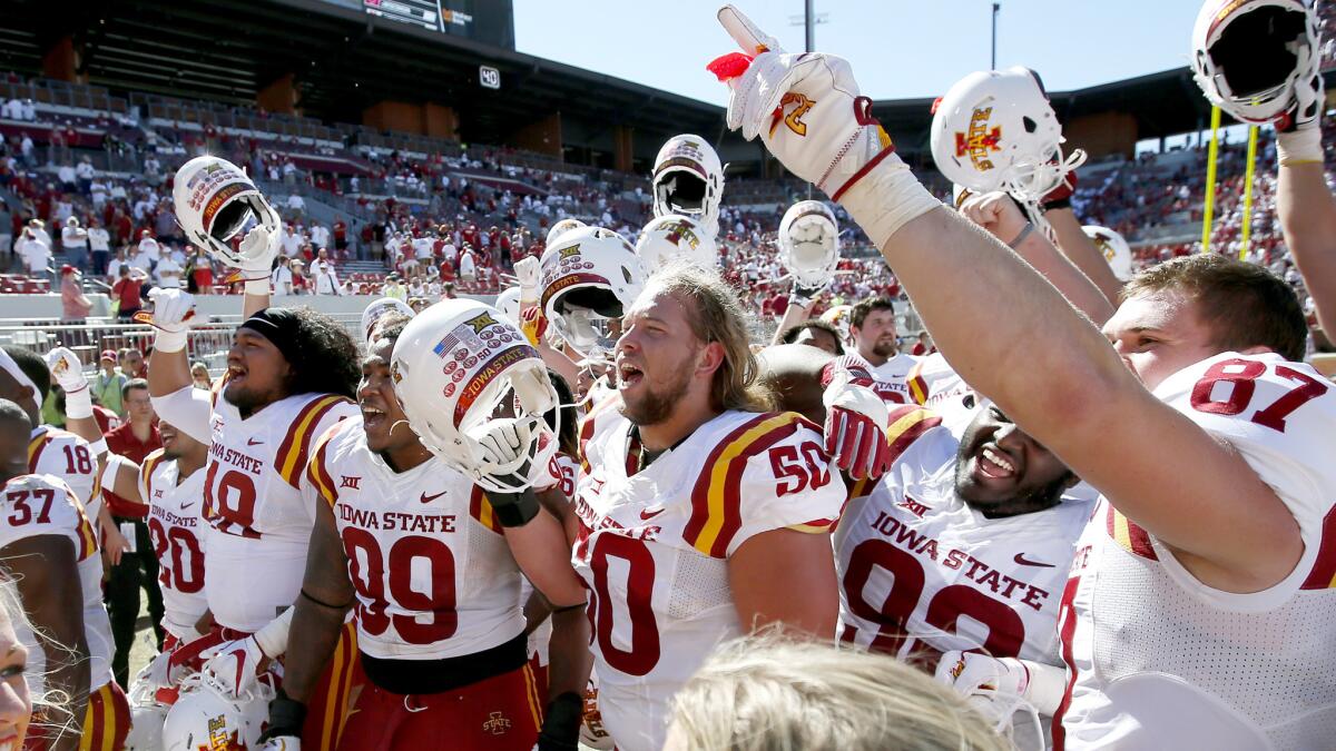 Iowa State players celebrate after upsetting third-ranked Oklahoma on the road Saturday.