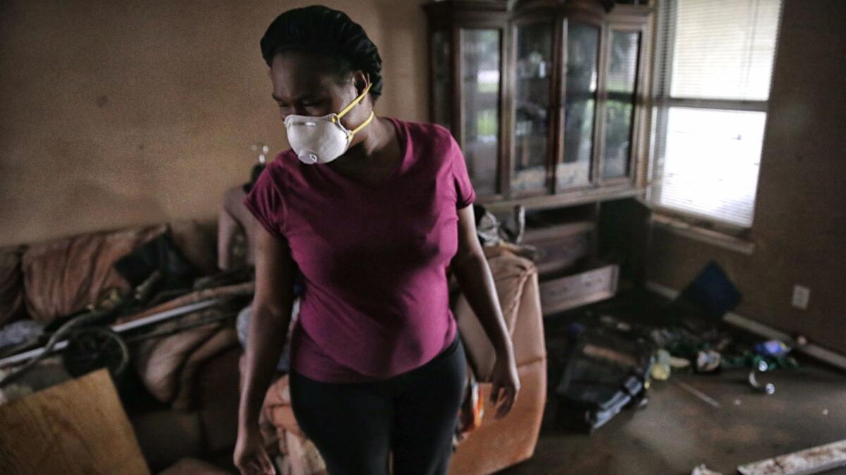 Kimberly Francis in the living room of her flood-damaged apartment.