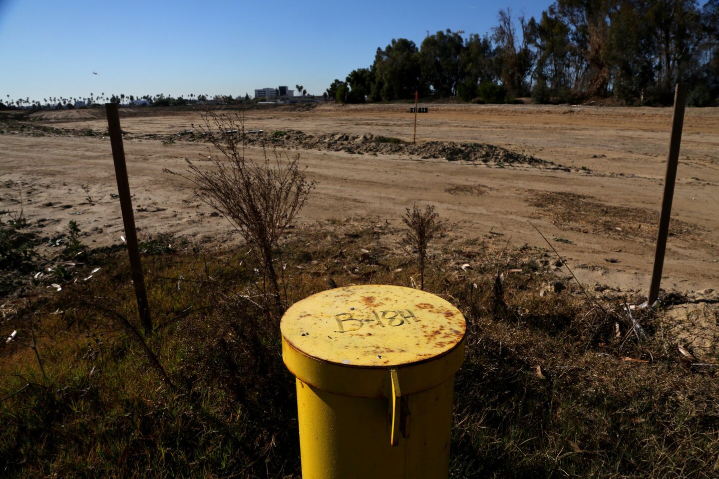 A yellow pipe marks the spot where the 50-yard line will be at the NFL stadium being constructed at the former Hollywood Park site in Inglewood.