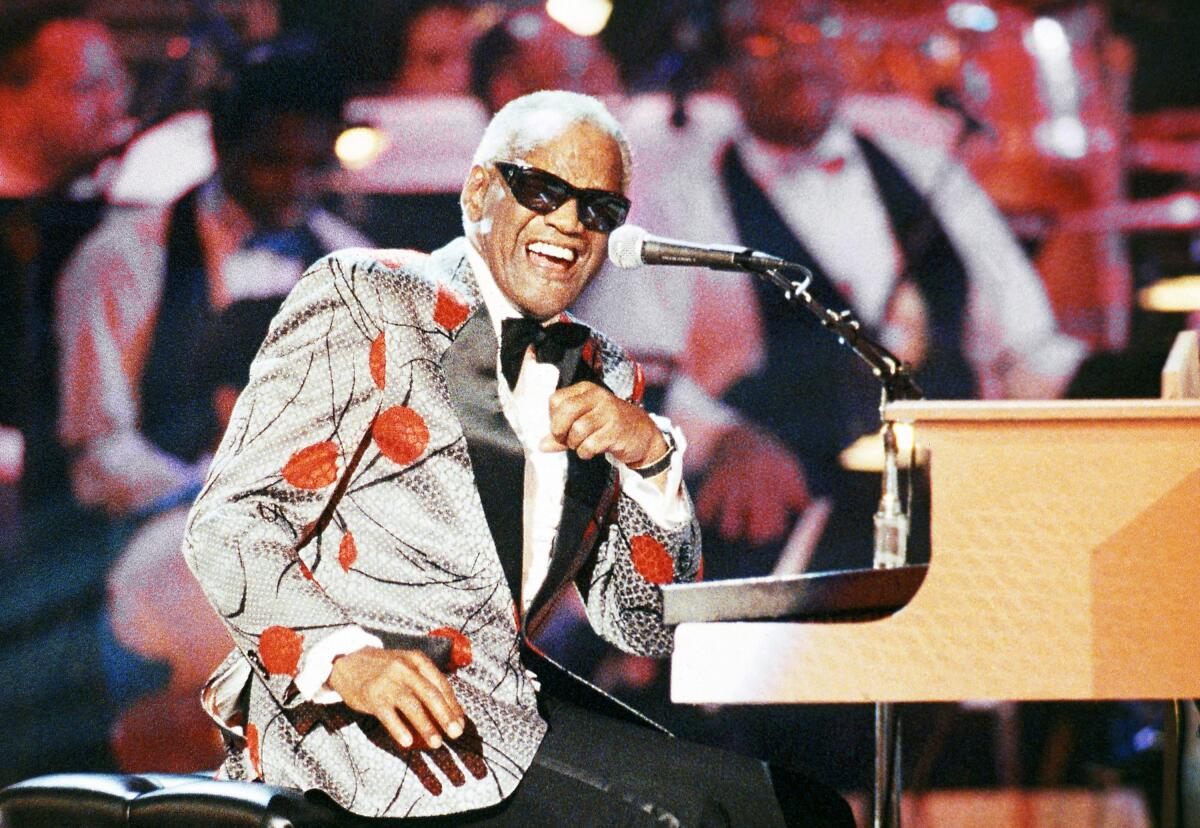 FILE - Ray Charles, performs during the taping of "Ray Charles: 50 Years in Music, uh-huh," a benefit musical gala for Starlight/Starbright Foundation in Pasadena, Calif. on Sept. 20, 1991. Charles will be inducted into the Country Music Hall of Fame. (AP Photo/Kevork Djansezian, File)