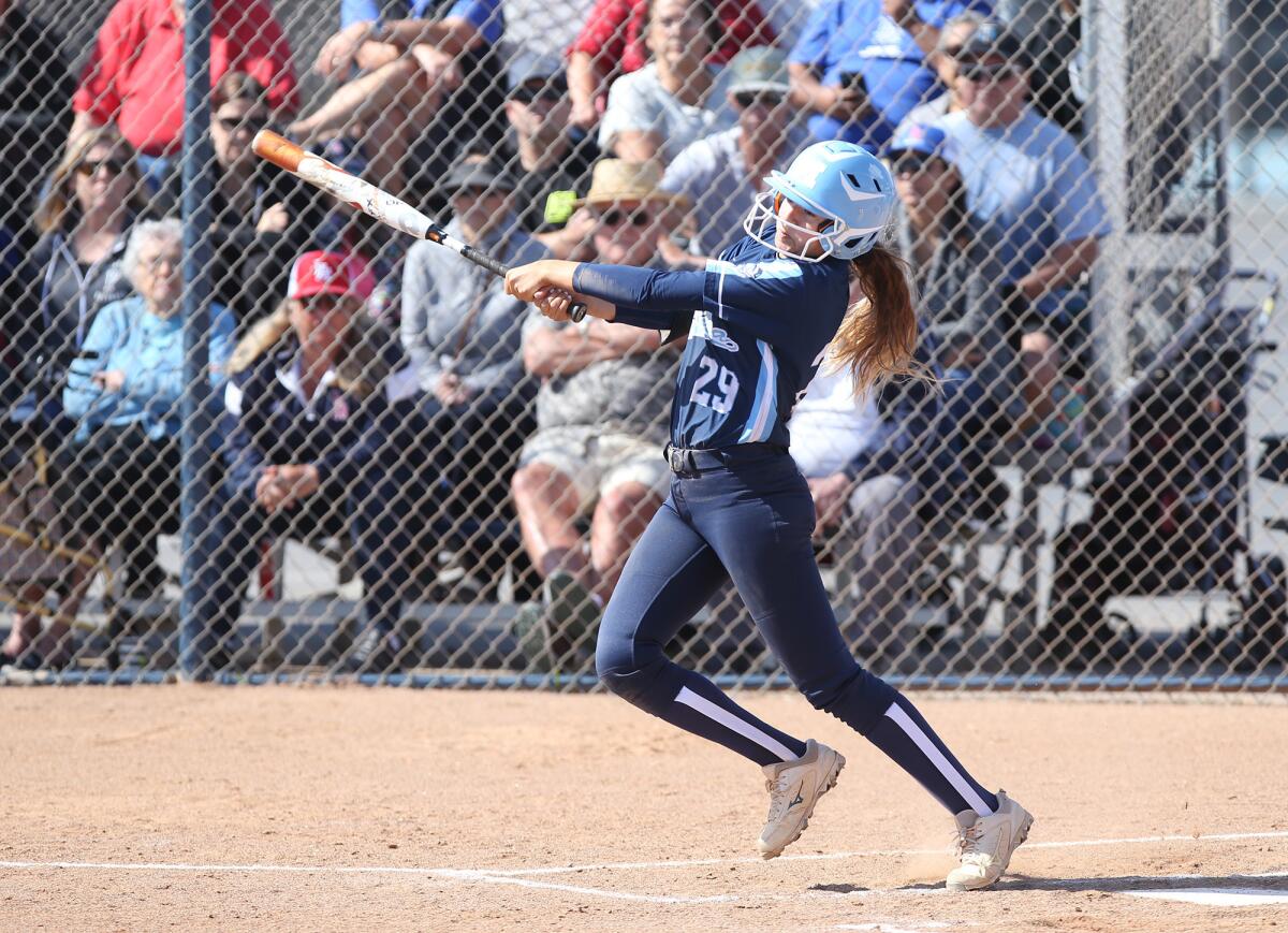 Marina High's Nicole Logrecco swings at a pitch in a Surf League home game against Los Alamitos on April 23.