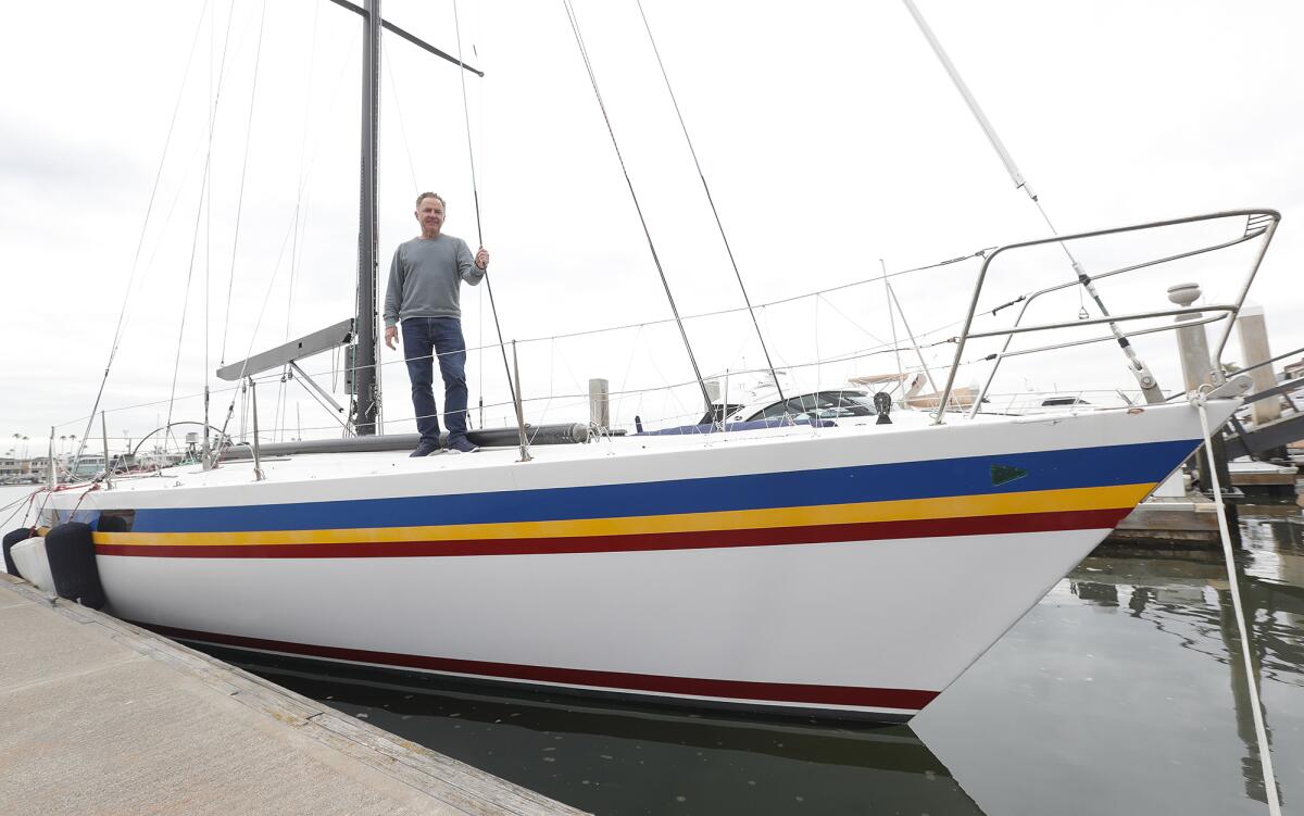 Buddy Richley stands on the deck of the racing boat Amante in Newport Harbor.