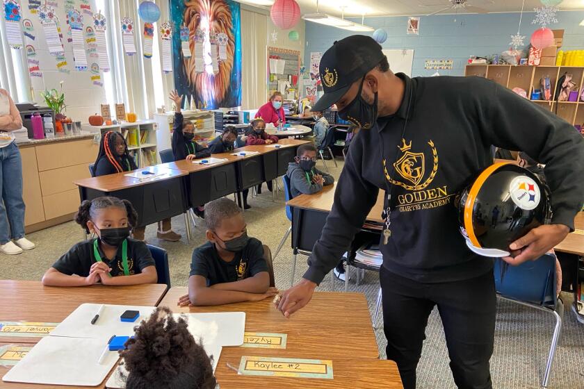 Former Steelers safety Rob Golden works with students at Golden Charter Academy in Fresno, Calif., on Nov. 18, 2021.