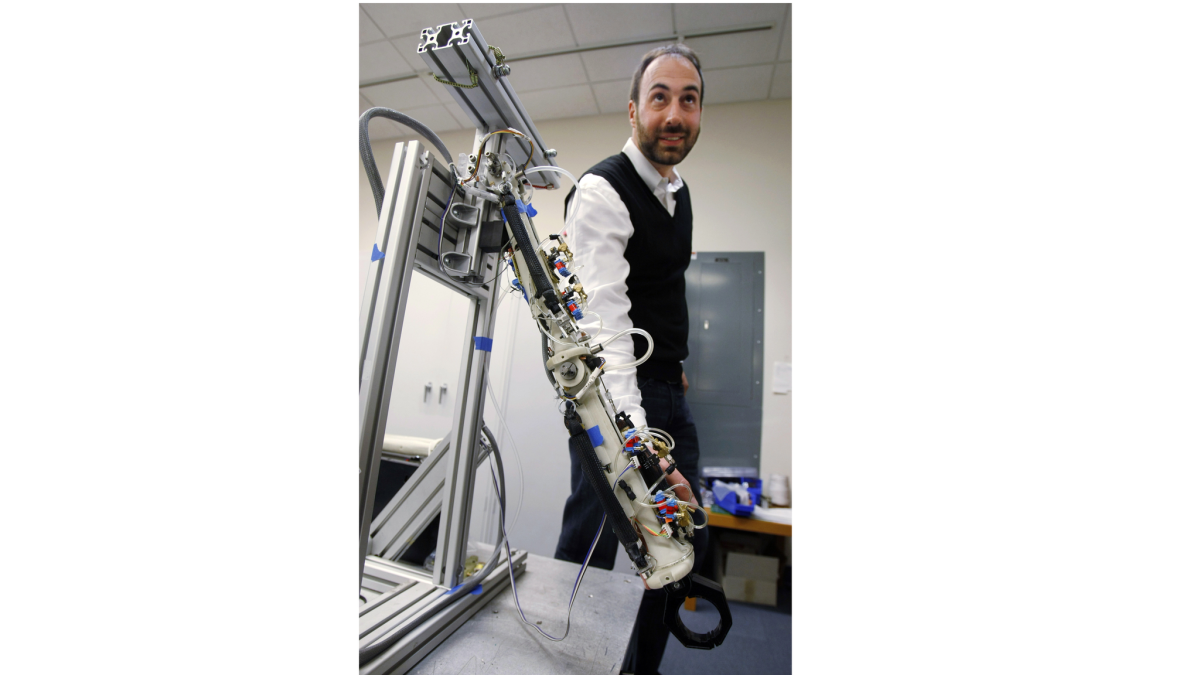 Ryan Calo, now a law professor at the University of Washington, stands with a robot at Stanford University in 2009. He specializes in the laws governing robotics.