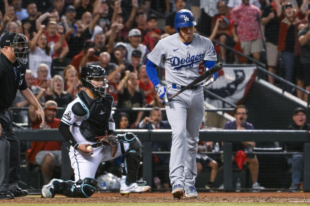 Dodgers star Freddie Freeman walks back to the dugout after striking out in the eighth inning.
