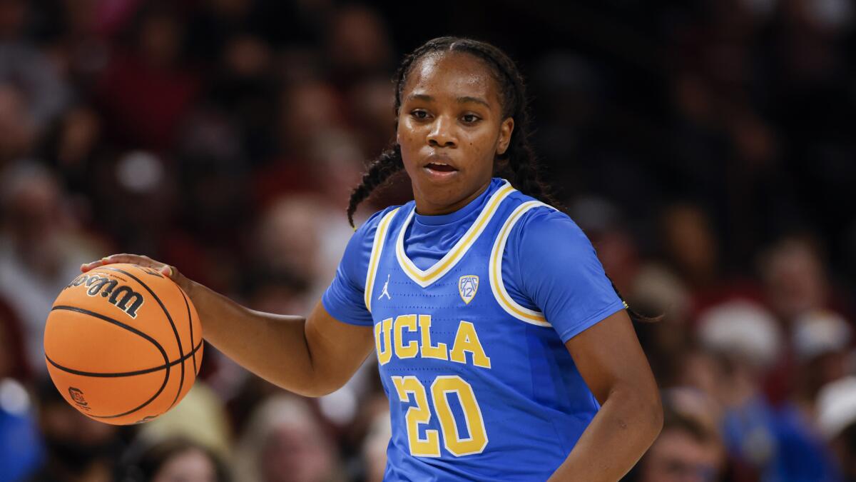 UCLA guard Charisma Osborne controls the ball during a game.