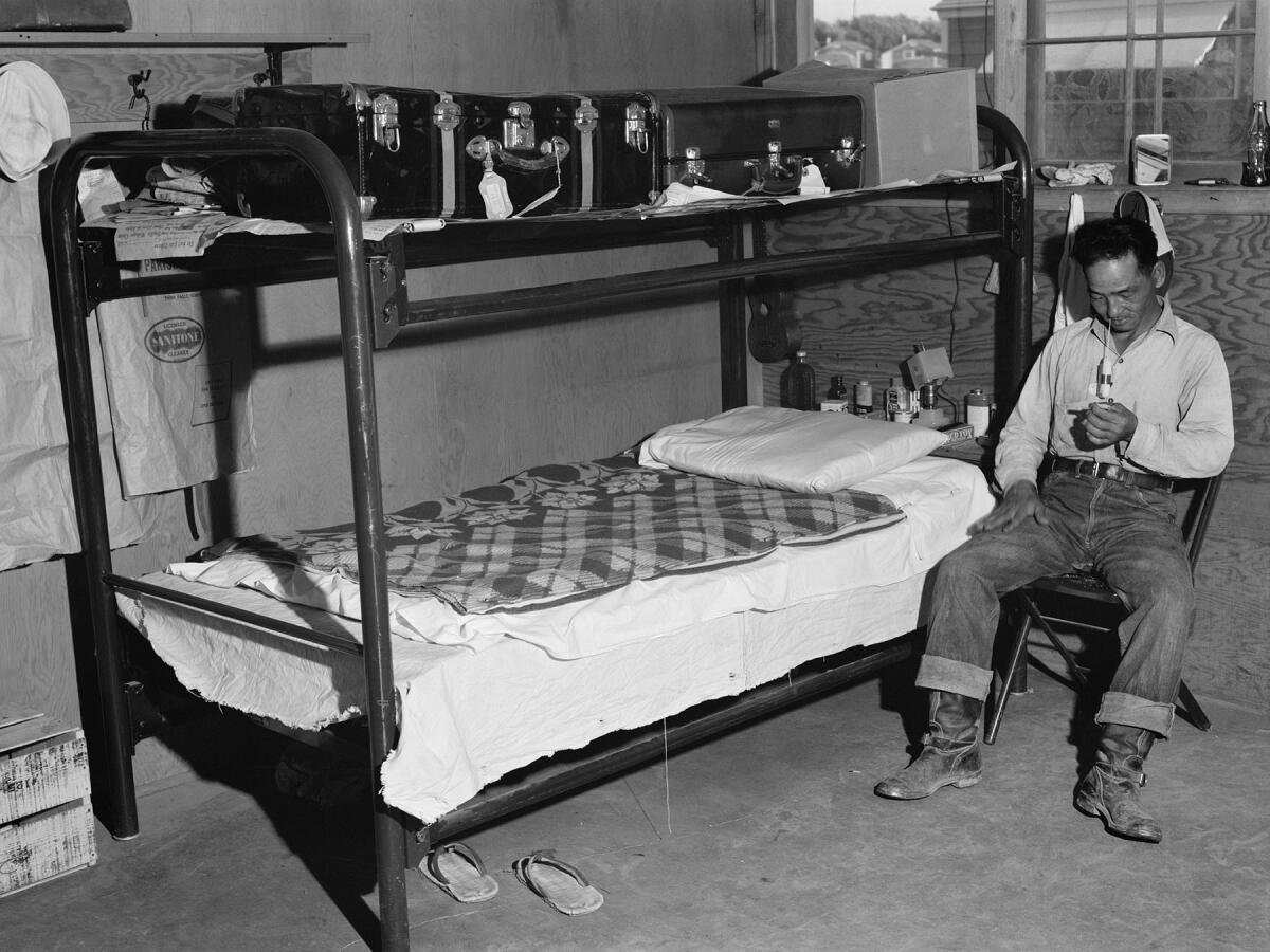 A 1942 photo of a barrack in the Twin Falls, Idaho, camp. Every barrack was divided into six apartments, each 14 feet by 16 feet. A typical apartment contained two pairs of bunk beds and a table with chairs. (Russell Lee / Library of Congress, Prints & Photographs Division, FSA-OWI Collection / Oregon Cultural Heritage Commission)