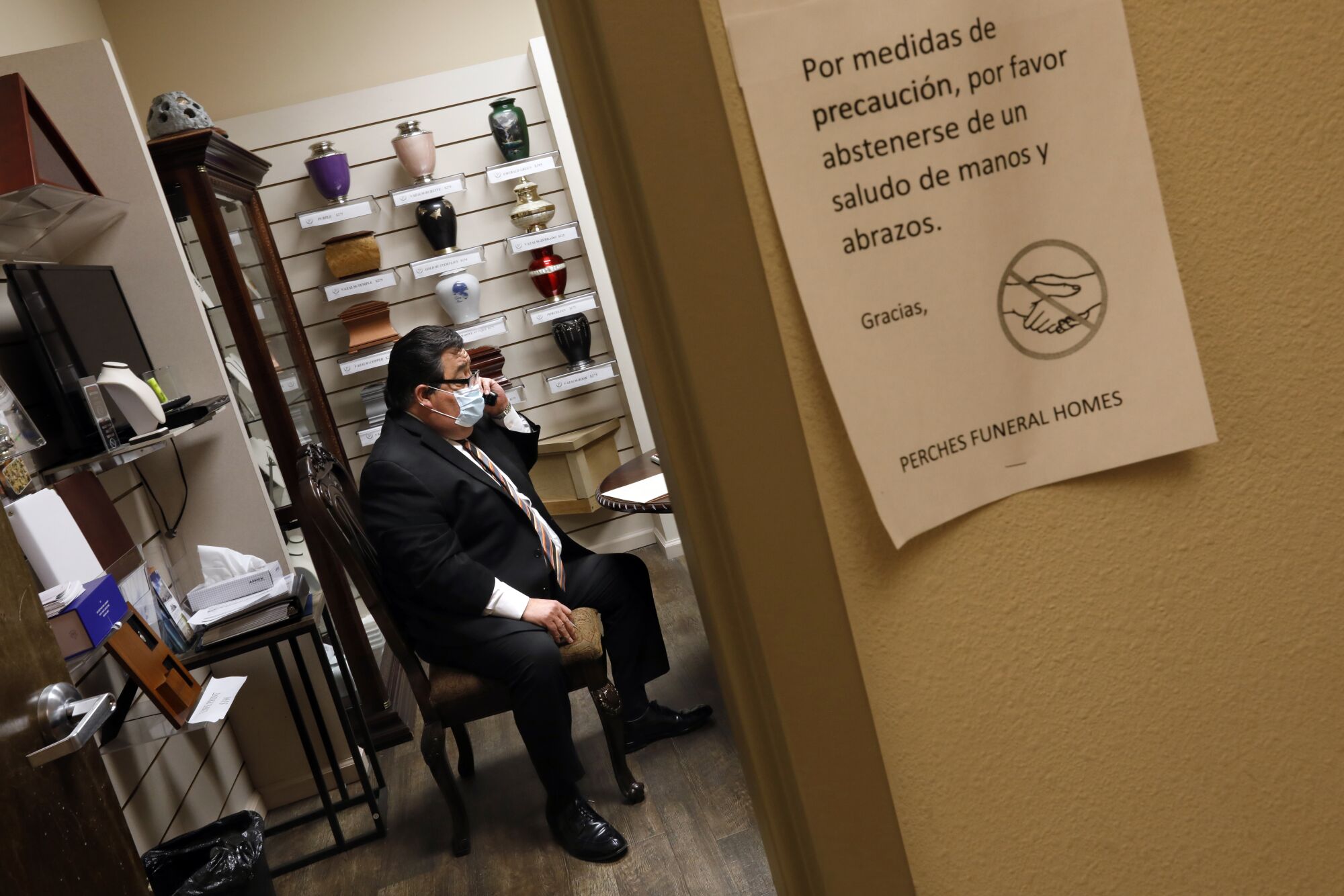Funeral director Richard Villa meets with a family at Perches Funeral Home in El Paso.