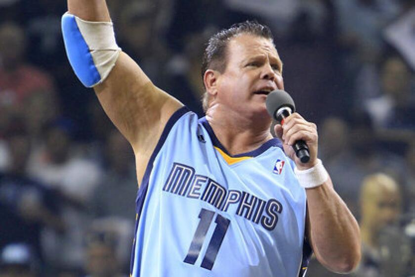 In an April 2011 file photo, Jerry Lawler gestures to fans before the start of Game 3 of a first-round NBA playoff series game between the San Antonio Spurs and the Grizzlies in Memphis, Tenn.