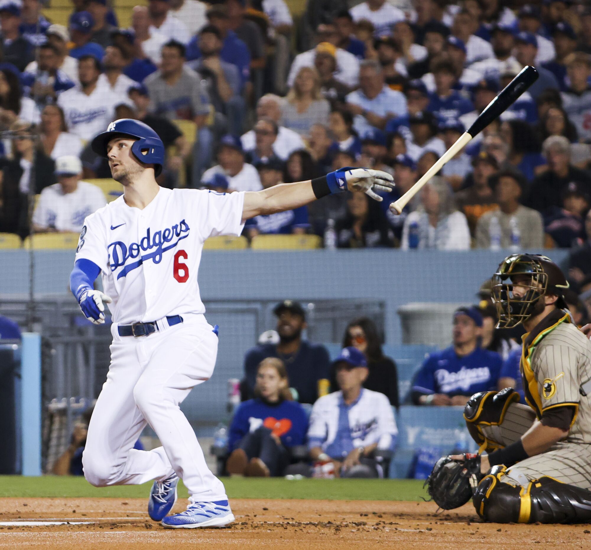 Dodgers' Trea Turner tosses his bat after hitting home run.