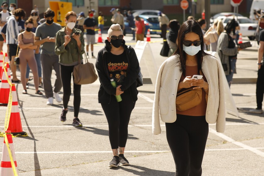 L.A., other areas giving everyone 16 and up COVID-19
vaccine. What you need to know 3 LOS ANGELES, CA - APRIL 08: Kristine Ko, right, from West LA waits for her vaccine shot with other people in line at the 9 a.m. opening of the Cal State L.A. walk-up mass vaccine site which is administering the Johnson & Johnson one dose shot between 9 a.m. and 7 p.m. Thousands of appointment slots there have gone unbooked by eligible people through the MyTurn registration system. As a result, vaccinators at the site have been allowed to inoculate adults walking up to the site without an appointment - including people outside of the eligibility criteria, said Brian Ferguson, a spokesman with the Office of Emergency Services. Anyone 18 and older will be allowed to wait in line to get the vaccine at the Cal State L.A. site between Thursday and Sunday night, Ferguson said. "As long as vaccines remain available, we'll vaccinate until we're out," he said. California State University Los Angeles on Thursday, April 8, 2021 in Los Angeles, CA. (Al Seib / Los Angeles Times).